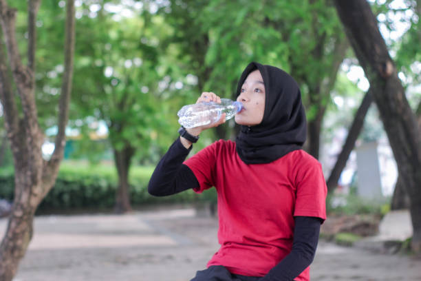 istock Beautiful Muslim women tired doing exercise at a public park 1346528579