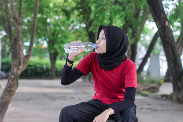 istock Beautiful Muslim women tired doing exercise at a public park 1346529006