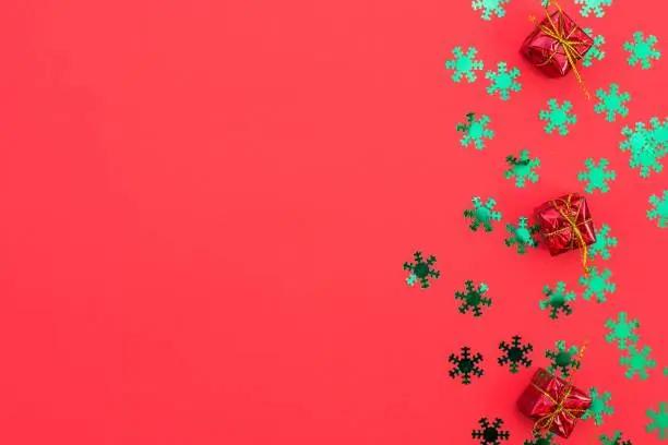 christmas composition of gifts and toys on red background. Winter wedding design. Flat lay, top view. Freeplace for text.