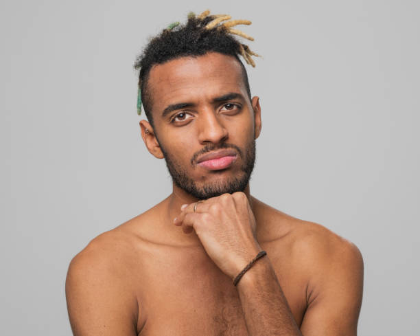 istock Close-up of thoughtful young man with hand on chin 1346530663