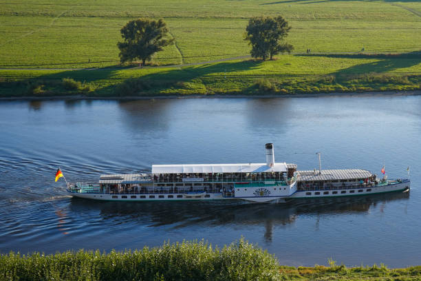 The paddle steamer "Leipzig" of the "Weiße Flotte" on the Elbe Dresden, Germany - September 10 2021: The paddle steamer PD Leipzig of the Sächsische Dampfschifffahrt on the river Elbe in Dresden. Dresden has the oldest fleet of active paddle steamers in the world. flotte stock pictures, royalty-free photos & images