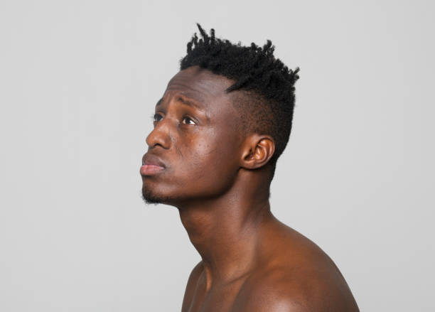 istock Close-up of thoughtful shirtless young man 1346531364