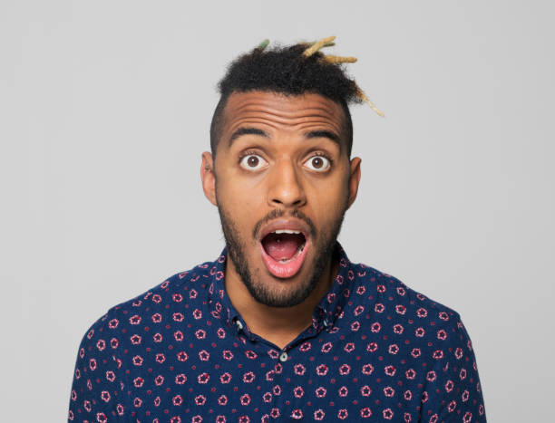 istock Close-up of shocked young man with mouth open 1346531415