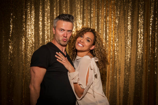 Portrait of happy man and woman enjoying party with props.