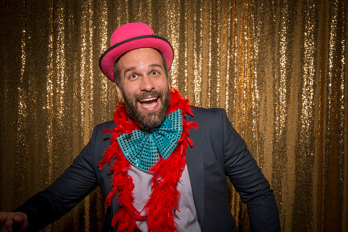 Portrait of happy mid adult man wearing props while enjoying the party.