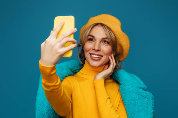 istock Beautiful emotional woman using smart phone 1346532177