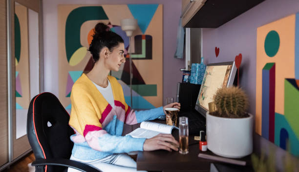Focused female freelancer, working on computer, from her modern and cozy room