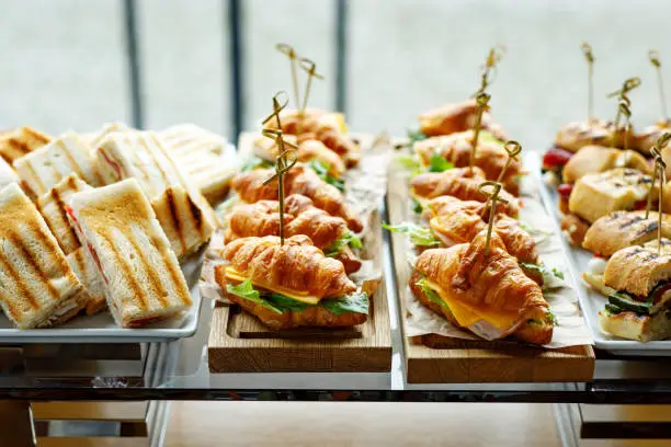 Photo of Stacks of croissant sandwich at event.