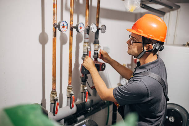 istock Electrician is working with heating pipes 1346534147