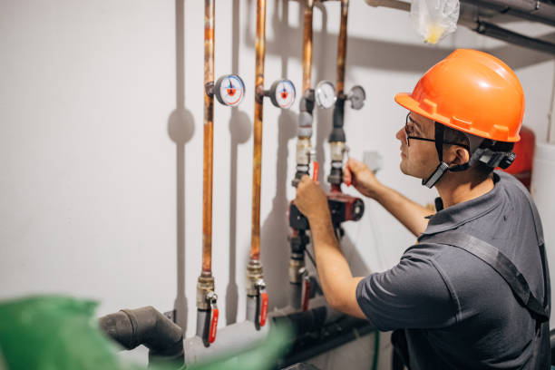 istock Electrician is working with heating pipes 1346534197