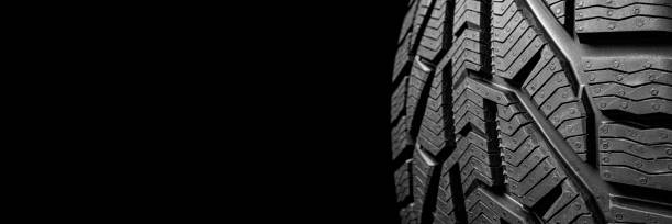 istock black isolation rubber tire, on the black backgrounds 1346536002