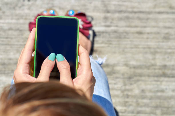 istock Female using modern smartphone outdoors. 1346536999