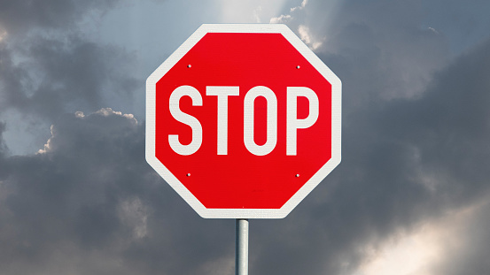 Stop sign and gloomy clouds in the background