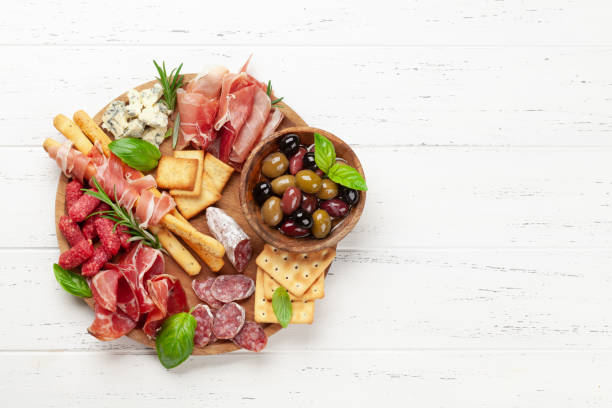 istock Antipasto board with prosciutto, salami, crackers, cheese, olives 1346537027