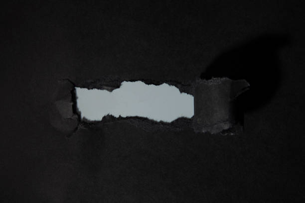 istock Black textured torn paper background for sale 1346537489