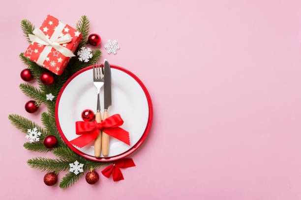 istock Christmas table place setting with christmas decor and plates, kine, fork and spoon. Christmas holiday background. Top view with copy space 1346537556