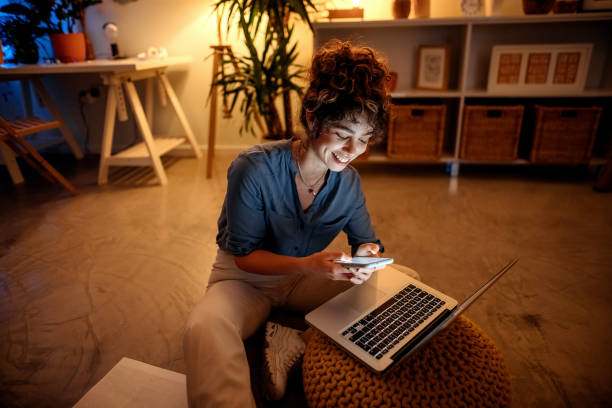 Young businesswoman working from home at night stock photo