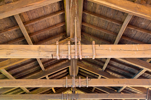 Old wooden truss structure called Palladian truss with beams and wooden roof
