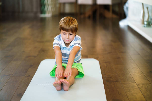 istock Small boy exercising at home 1346542758