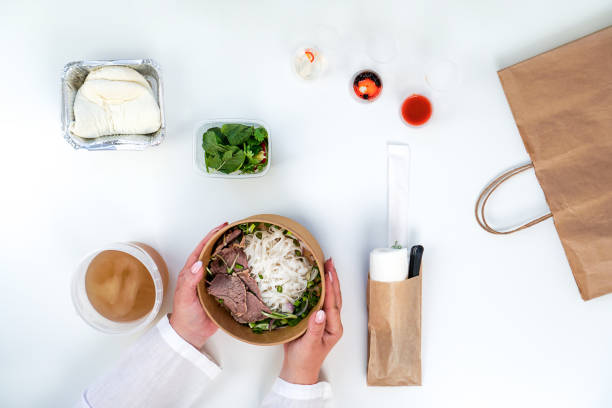 Layout of ingredients for Vietnamese pho bo soup. Delivery of Vietnamese cuisine. Plastic containers.