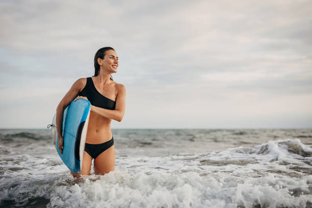 istock Beautiful female surfing 1346546099