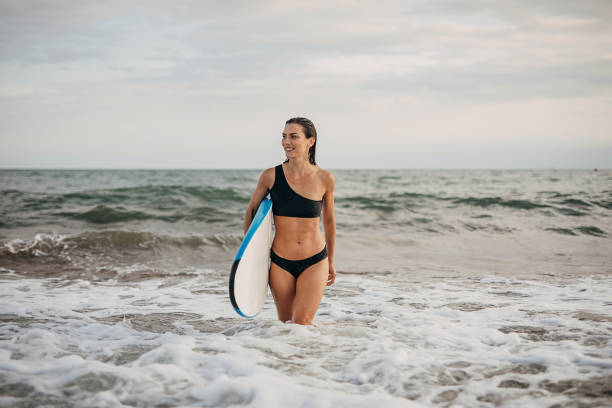 istock Beautiful female surfing 1346546163