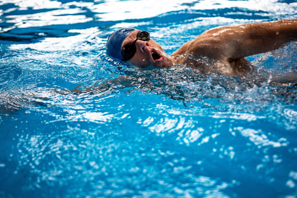 istock Swimmer swimming competition pool 1346549030