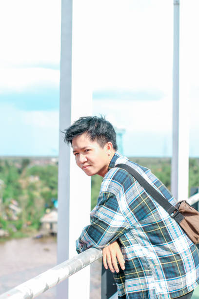 istock Young Men walking enjoying at the bridge in sunny day 1346550295