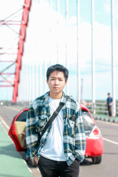 istock Young Men walking enjoying at the bridge on sunny day 1346550477