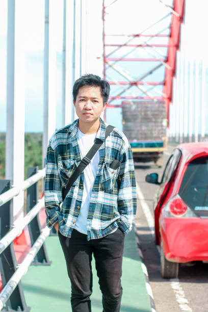 istock Young Men walking enjoying at the bridge on sunny day 1346550482