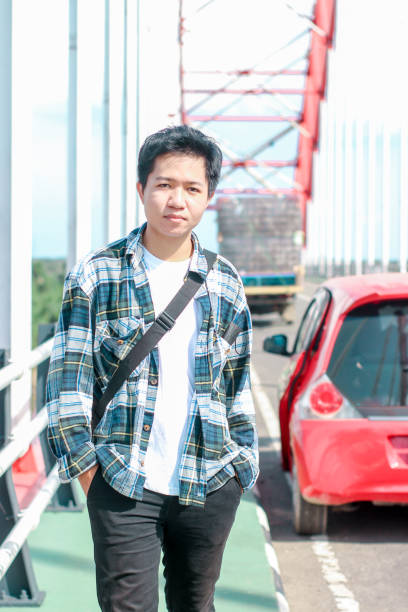 istock Young Men walking enjoying at the bridge on sunny day 1346550483