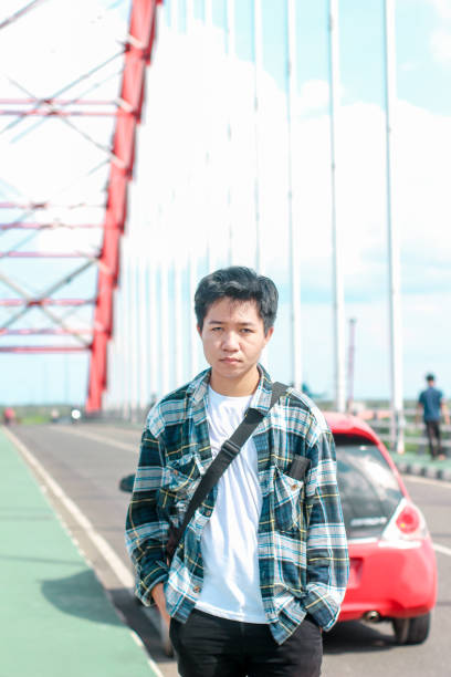 istock Young Men walking enjoying at the bridge on sunny day 1346550484