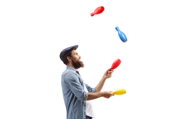 profile shot of a juggler juggling with clubs - unicycle unicycling cycling wheel imagens e fotografias de stock