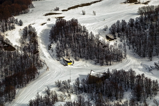 Cimone mountain ski track snowed aerial view, Appenino Tosco Emiliano, Modena, Italy