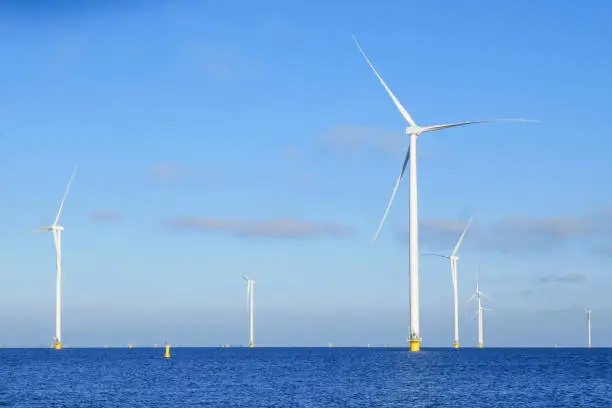 View on offshore Wind-turbine standing in Netherland in sea (markermeer). Sunny weather.