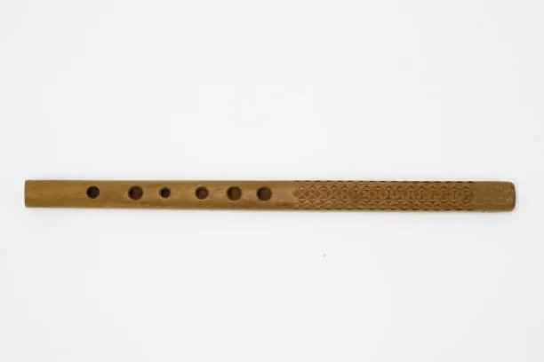 Traditional musical instrument - woodwind folk flute on the white background.