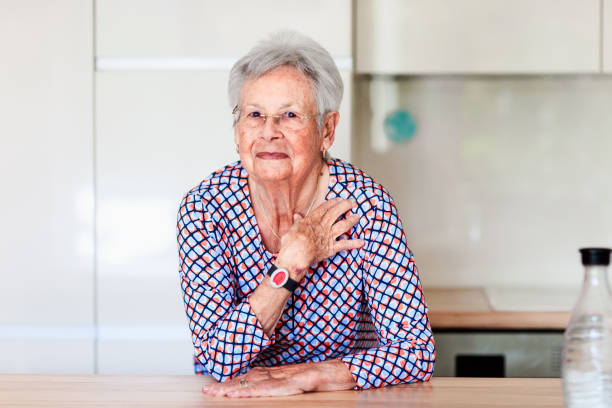 istock Senior woman with emergency alarm button 1346554325
