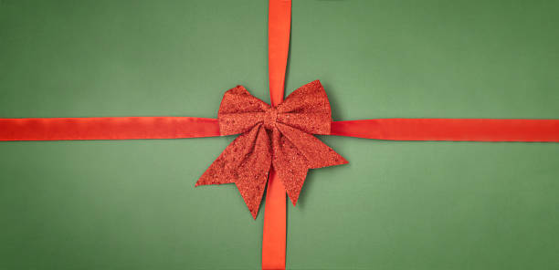 istock Christmas background with red bow on green 1346554663