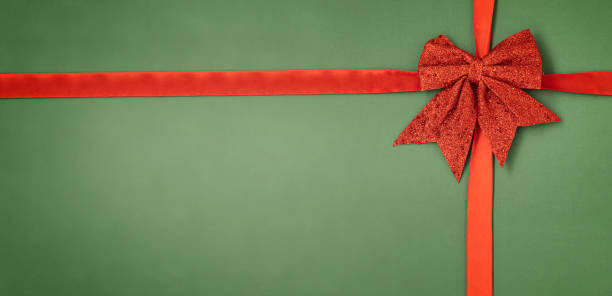 istock Holiday background with red bow on green 1346554665
