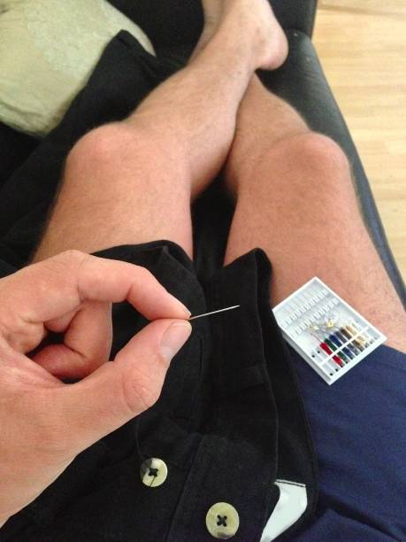 Mending some trousers. stock photo