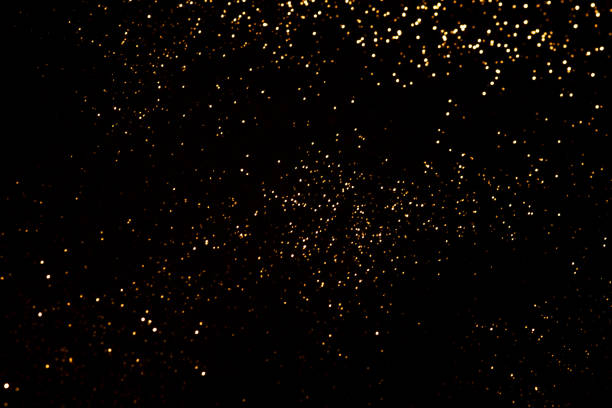 istock Golden abstract bokeh on black background. 1346554912