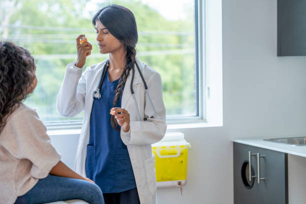 istock Doctor Instructing a Young Patient on Proper Inhaler Usage 1346555524