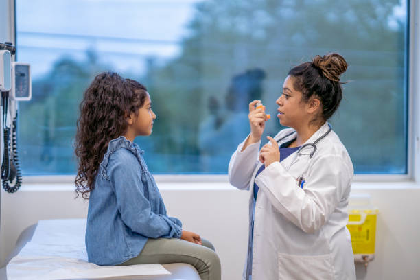 istock Doctor Instructing a Young Patient on Proper Inhaler Usage 1346555546