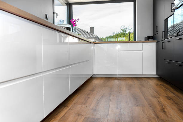 istock A modern kitchen with built in cabinets against the wall with white fronts, vinyl panels on the floor. 1346558234