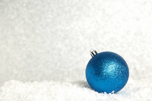 istock Shiny blue Christmas ball on glittering background 1346558278