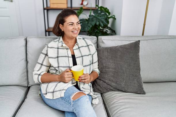 istock Middle age hispanic woman smiling confident drinking coffee at home 1346558307