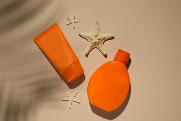 istock Sun protection products and starfishes on beige background, flat lay 1346558756