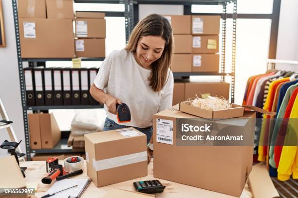 Young Hispanic Woman Smiling Confident Working At Store Stock Photo - Download Image Now