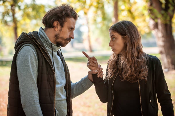 istock Young couple in quarrel conflict, pointing each other with finger 1346566032