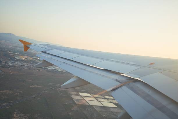 istock Cloudscape from window airplane, landscape of wing plane on a cloudy sky 1346566287
